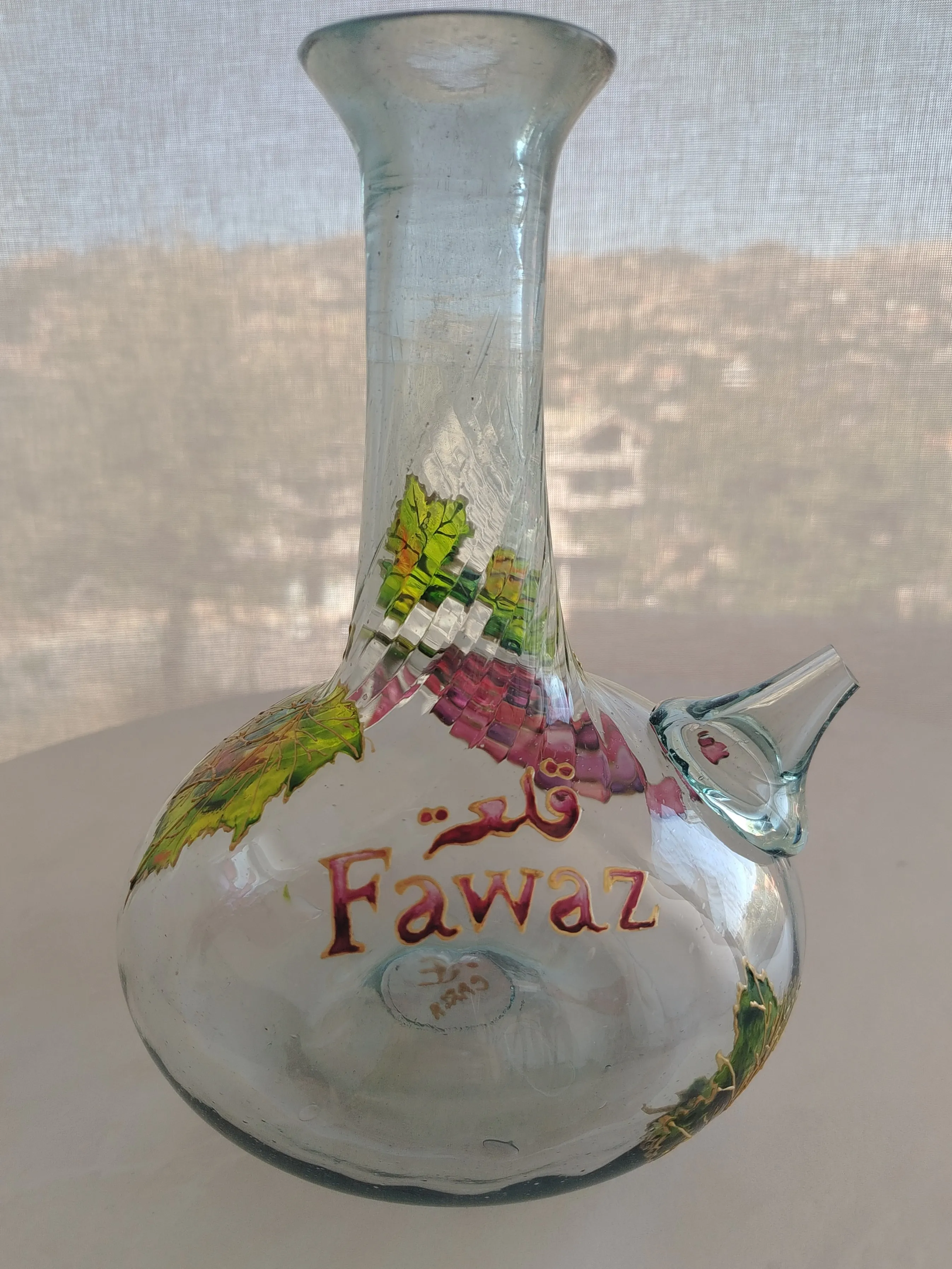 Hand-painted Lebanese glass jug depicting a Mount Lebanon village scene in earth tones and gold